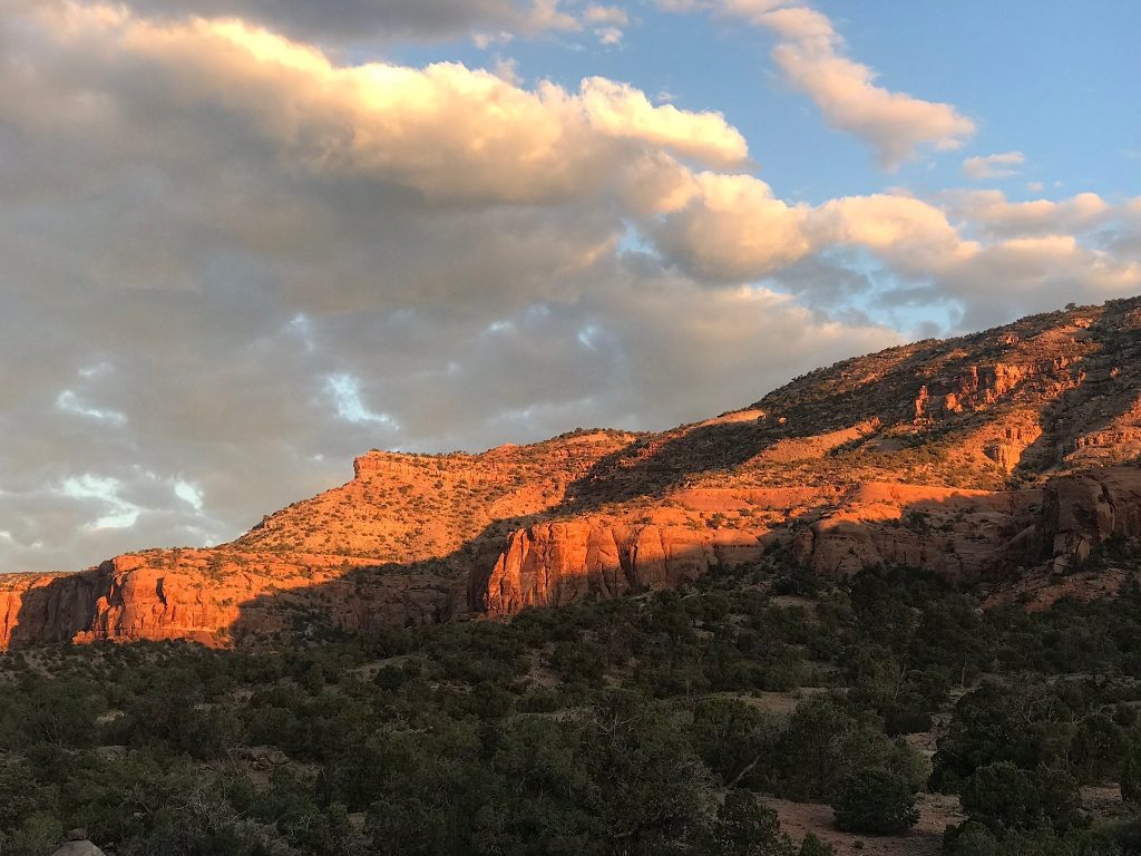 Spectacular sunrise and full moon setting on canyon walls during Dominguez Escalante camping trip.
