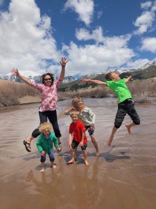 Family with kids Splashing in Medano Creek Sand Dunes National Park