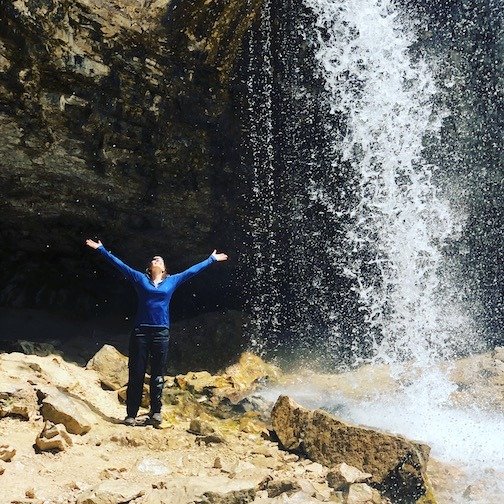 Enjoying the refreshing spouting rock waterfall spray after hiking Haning lake trail