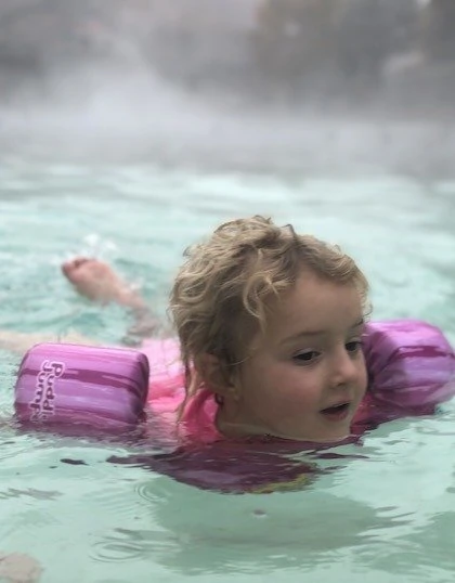 Toddler swimming in the hot springs
