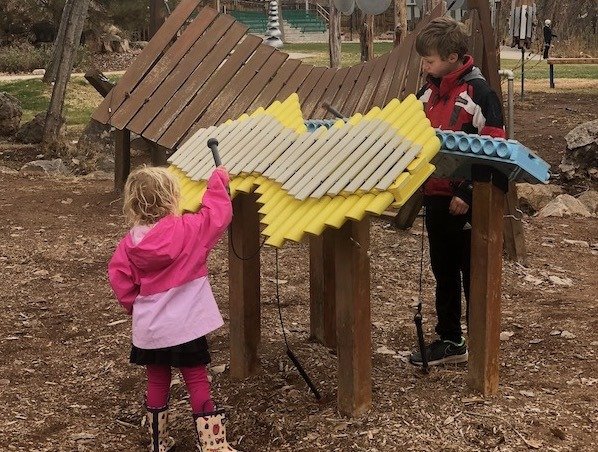 Toddler and kids making music at Rotary Park in Moab