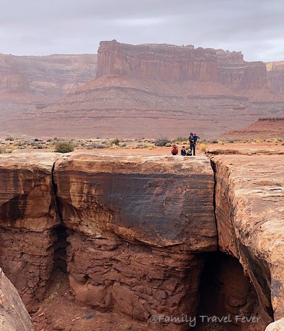 Family enjoying Musselman Arch  Trail in Canyonlands National Park - best hikes for kids in Canyonlands