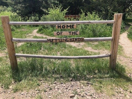 Entrance to the Home of the Hummingbirds is this sign off FR 500
