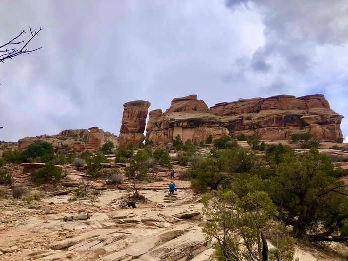 A great view of the rock formation from the Devil's Kitchen Trail with two people in blue jacket hiking up