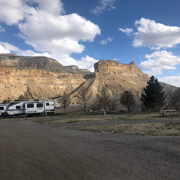 mountain view in the Palisade RV basecamp with 2 white RV parked at camp