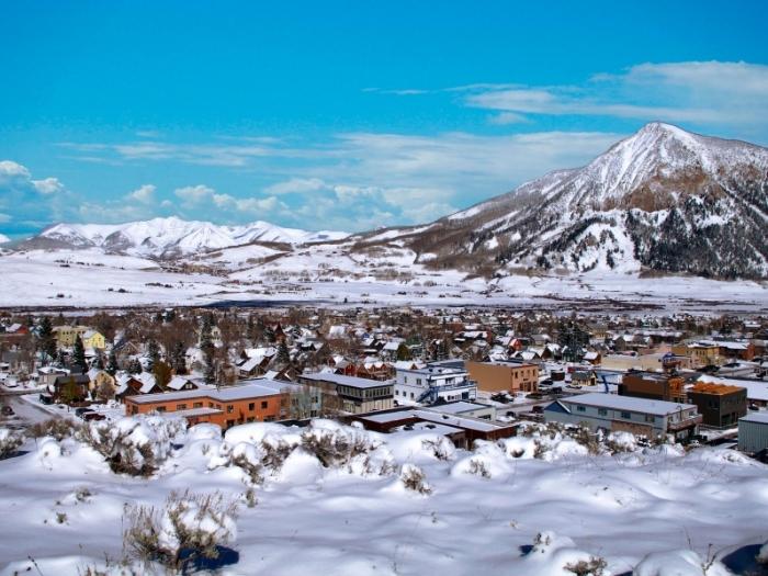 panoramic view of Crested Butte Town with snowy mountains in the background
