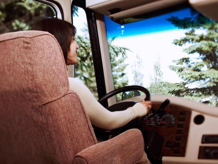 A woman on the driver's seat of an RV