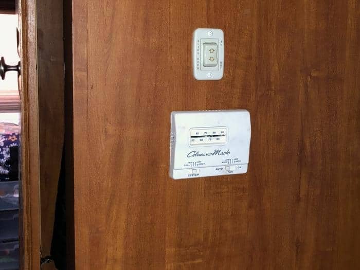 An RV thermostat in an interior RV wall