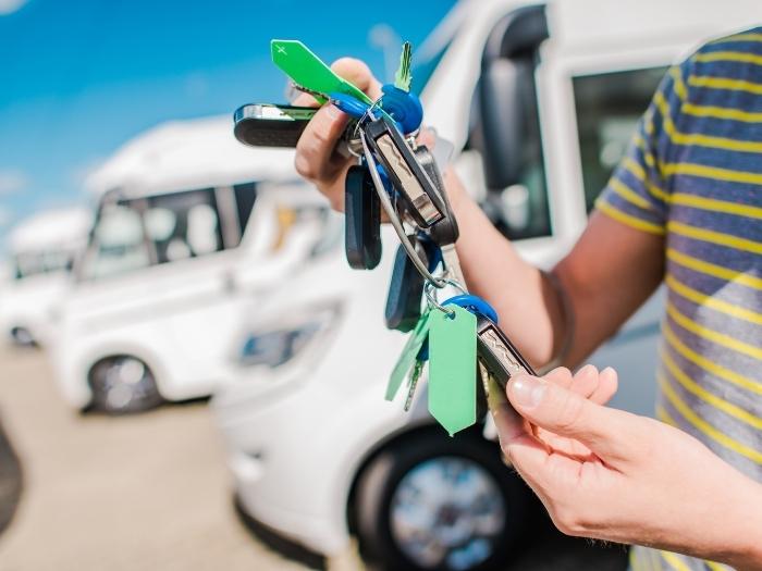 A set of keys dangly handled with different kinds of motorhome background
