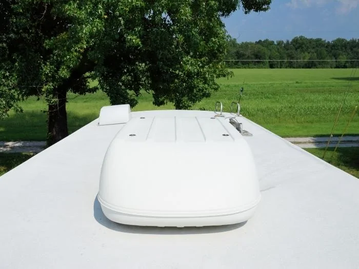 Photograph on roof of recreational vehicle looking into large field.