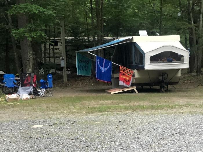 Pop up camper at a camp ground with fabric awning