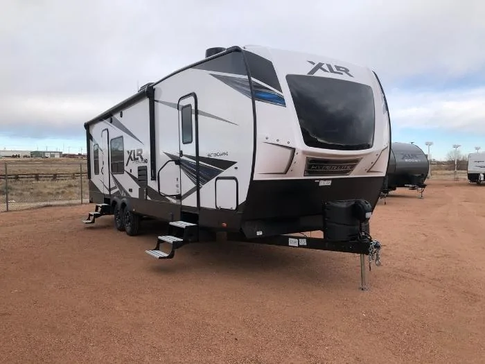 A travel trailer set up in a dessert like campground