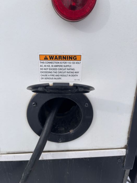 Warning for an RV 110-volt outlet