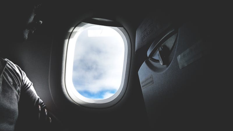 Passenger looking through airplane window