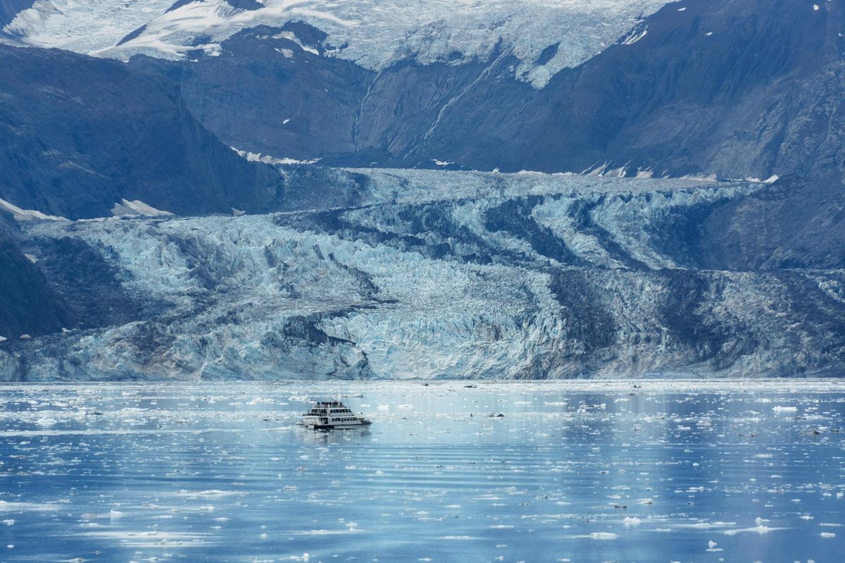 Glacier and mountains in Alaska with calm water in the foreground