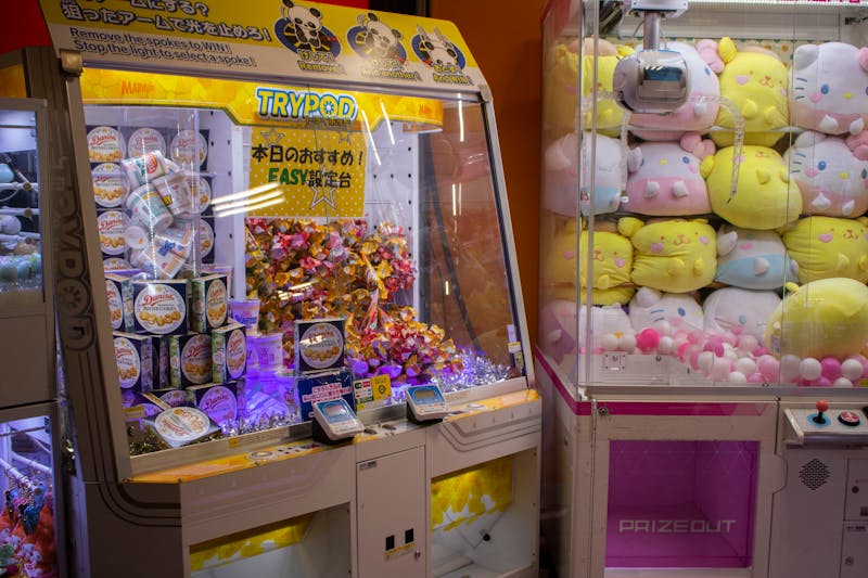 Vibrant arcade scene with candy and plush toy claw machines in Shibuya Tokyo