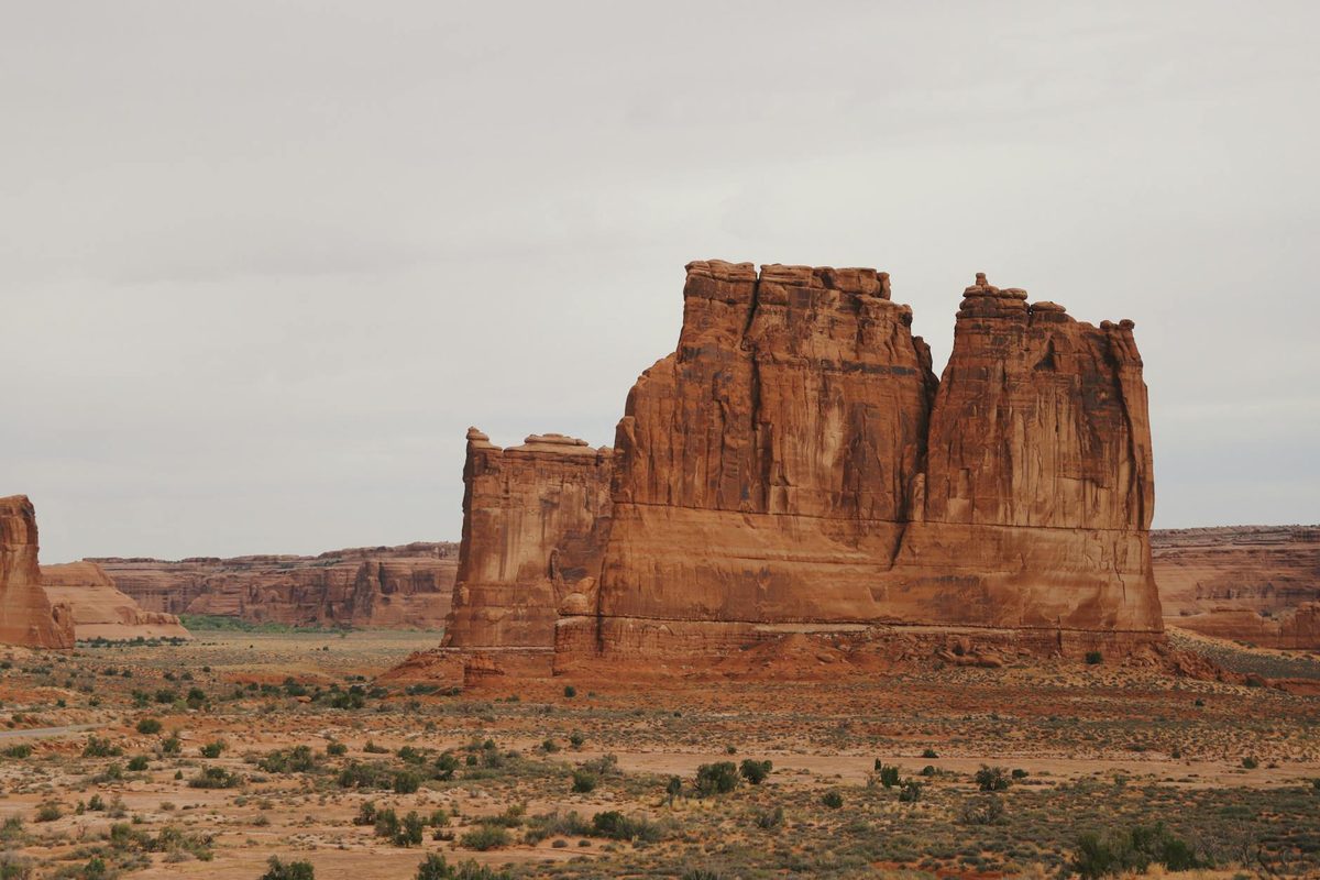 Natural stone arch formation in Arches National Park with blue sky