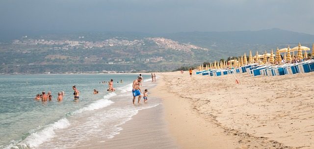 Family silhouettes walking on the beach at sunset