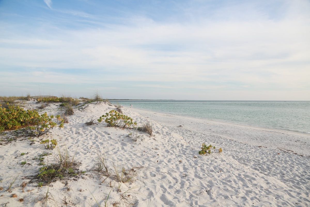 Emerald green water meets white sand on a Florida Panhandle beach