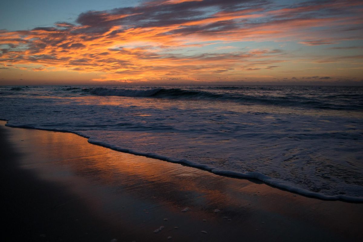 Golden sunrise over a wide empty beach on the Outer Banks of North Carolina