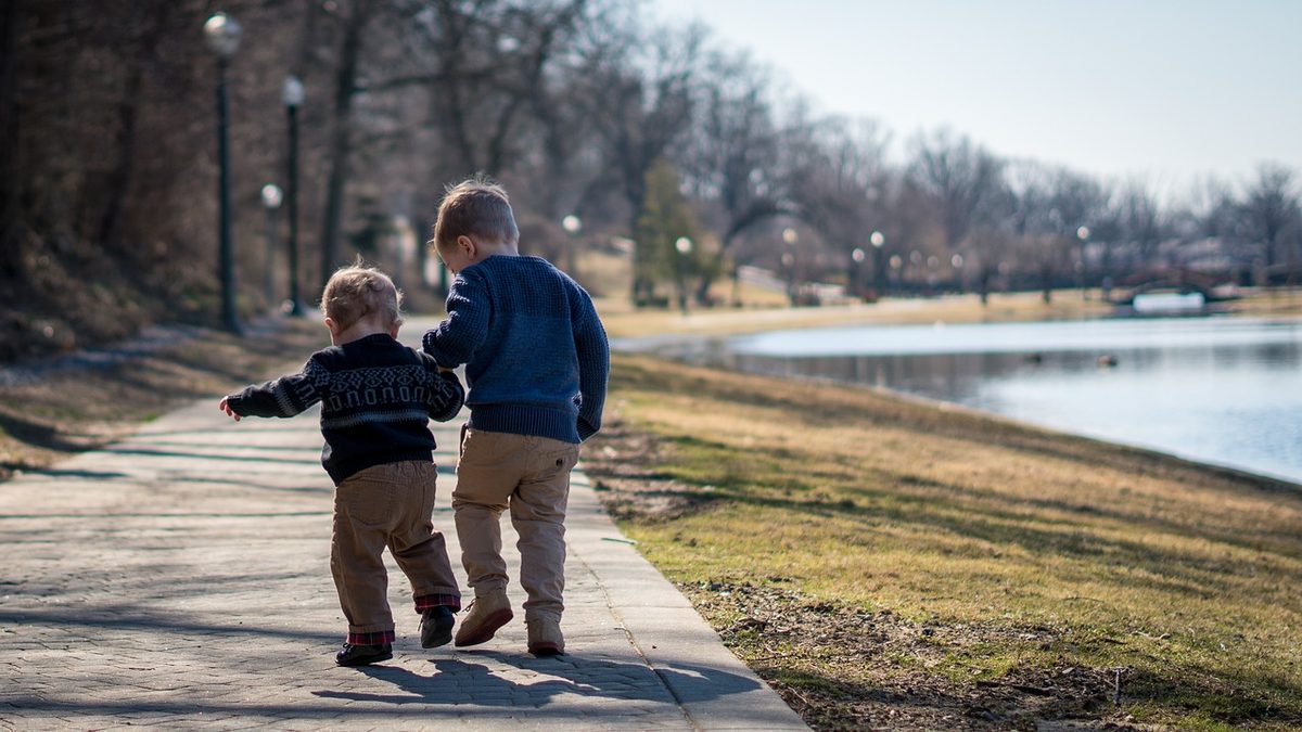 Family walking together holding hands on a sunny day
