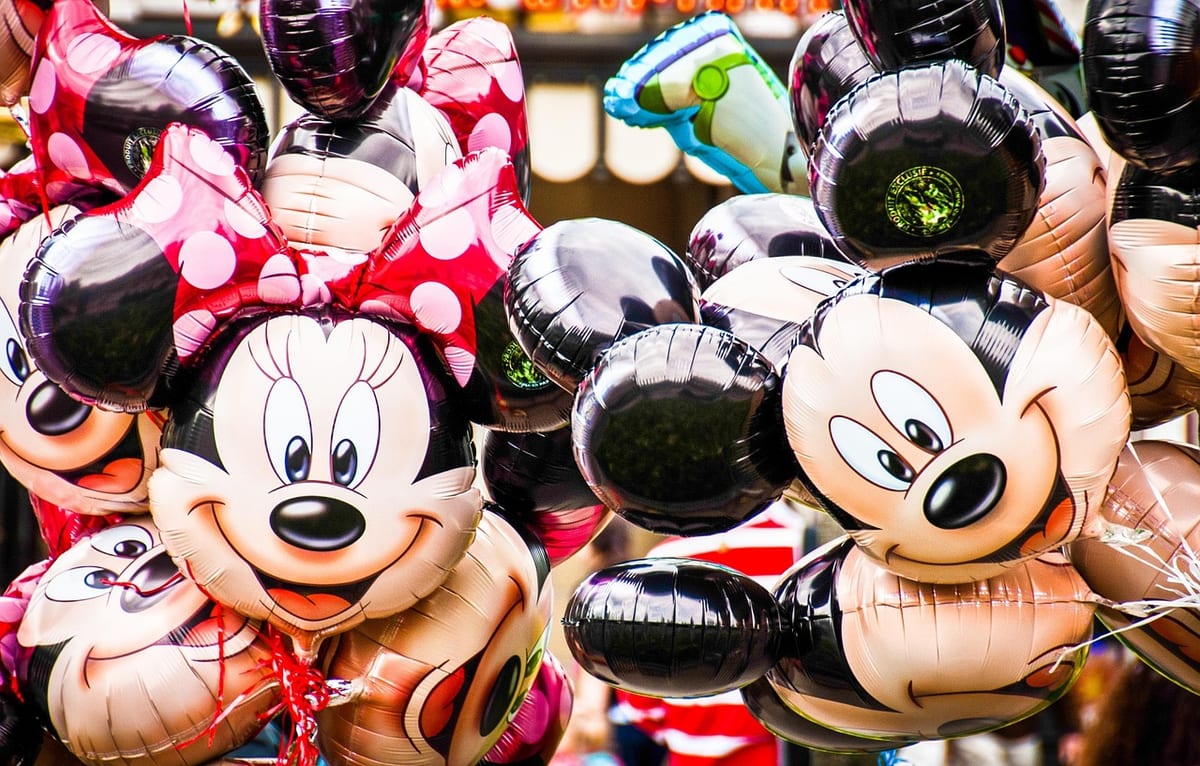 Colorful Mickey Mouse balloons at a Disney theme park