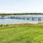 Sandy shoreline on Cape Cod with gentle waves rolling in on a summer afternoon