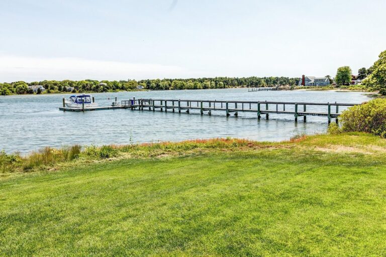 Sandy shoreline on Cape Cod with gentle waves rolling in on a summer afternoon