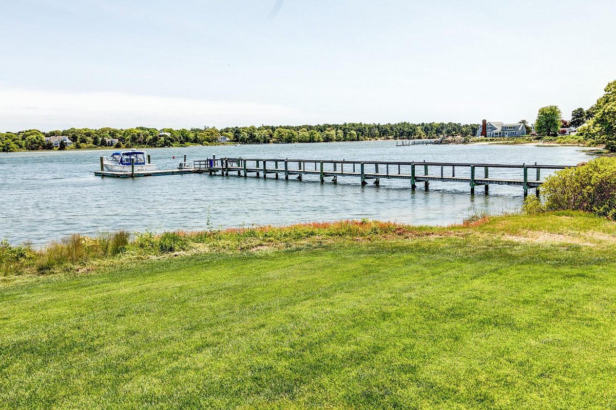Sandy shoreline on Cape Cod with gentle waves rolling in on a summer afternoon