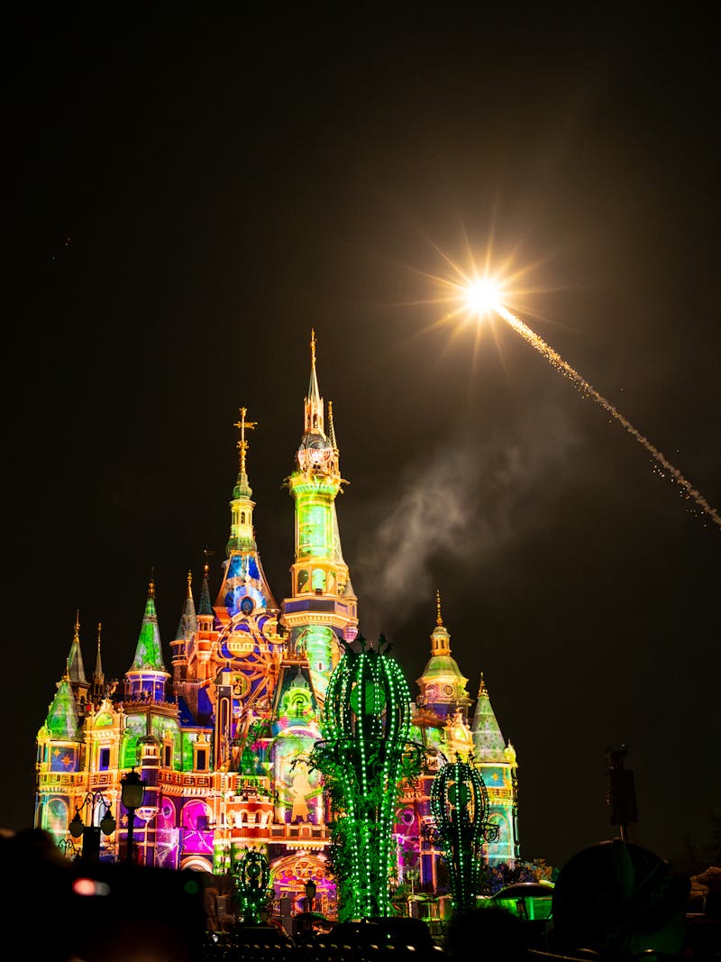 Fireworks illuminating a Disney castle at night