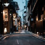 Narrow Kyoto street with lanterns at dusk