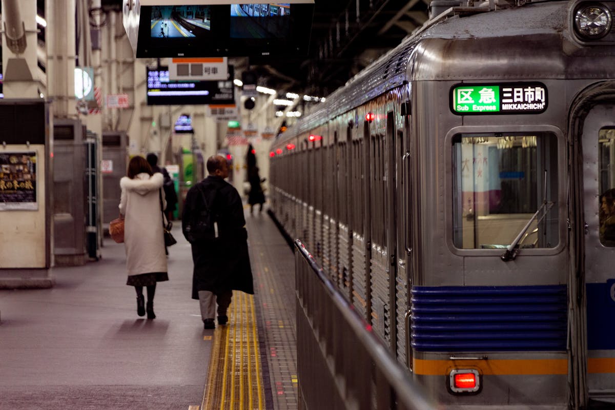 Travelers walking through a busy Japanese train station