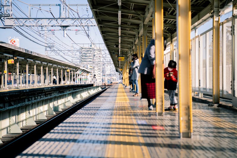 Vibrant scene at a Japanese train station with commuters