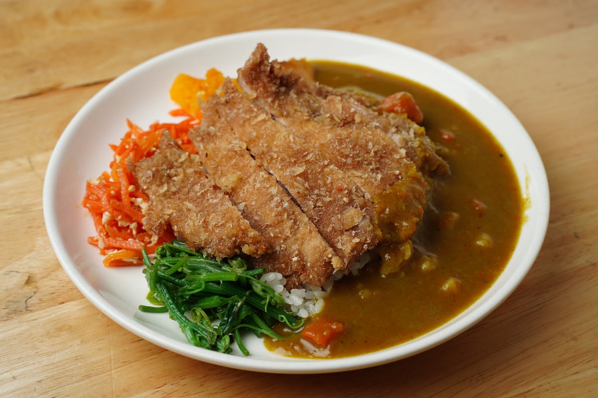 A plate of Japanese curry rice with breaded cutlet