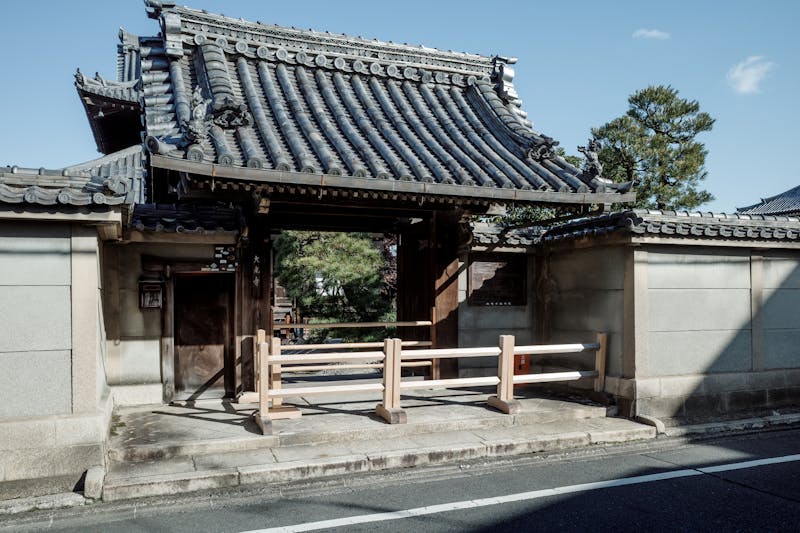 Traditional Japanese temple gate with wooden structure and tiled roof in Kyoto