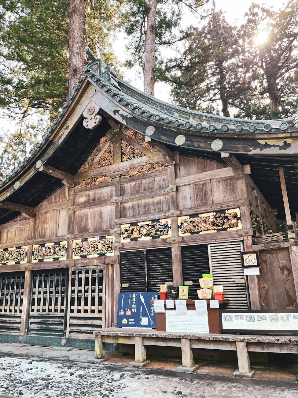 Ornate Toshogu Shrine surrounded by tall trees in Nikko Japan