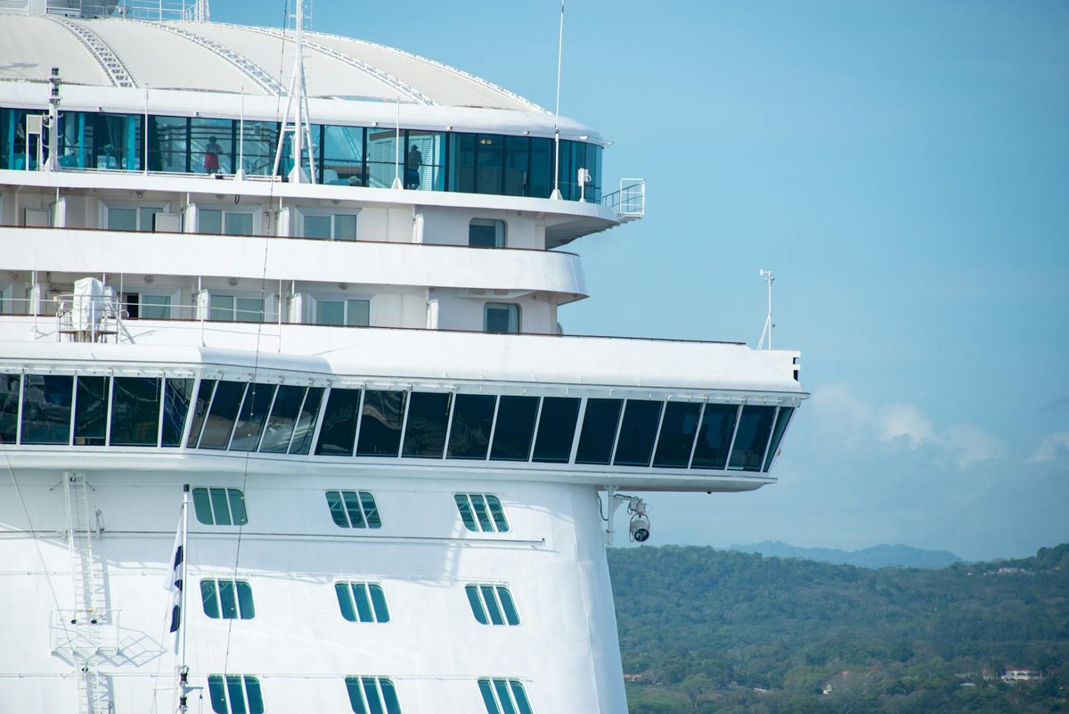 Cruise ship docked at port with blue sky
