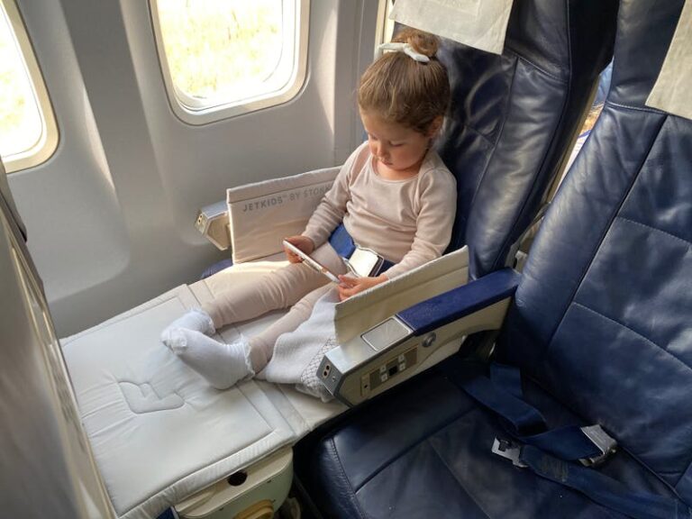 Girl using tablet on airplane