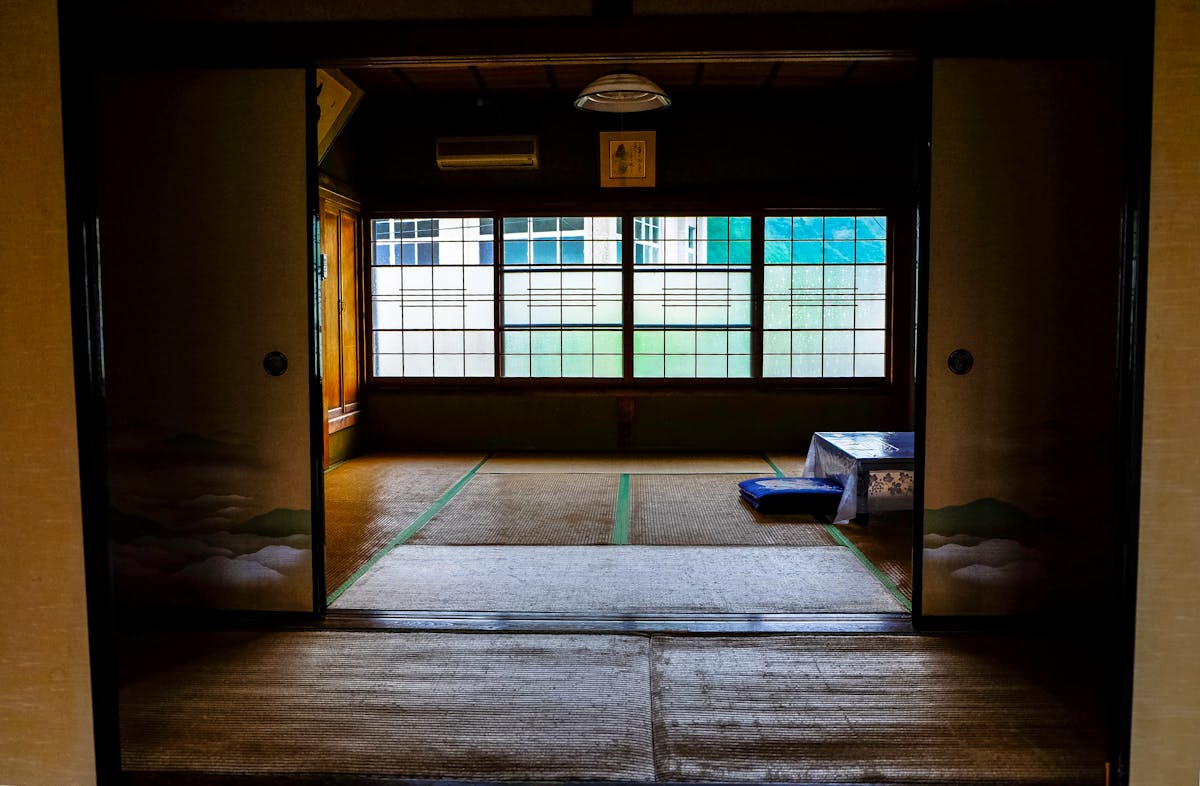 Traditional Japanese ryokan room with tatami flooring and sliding doors