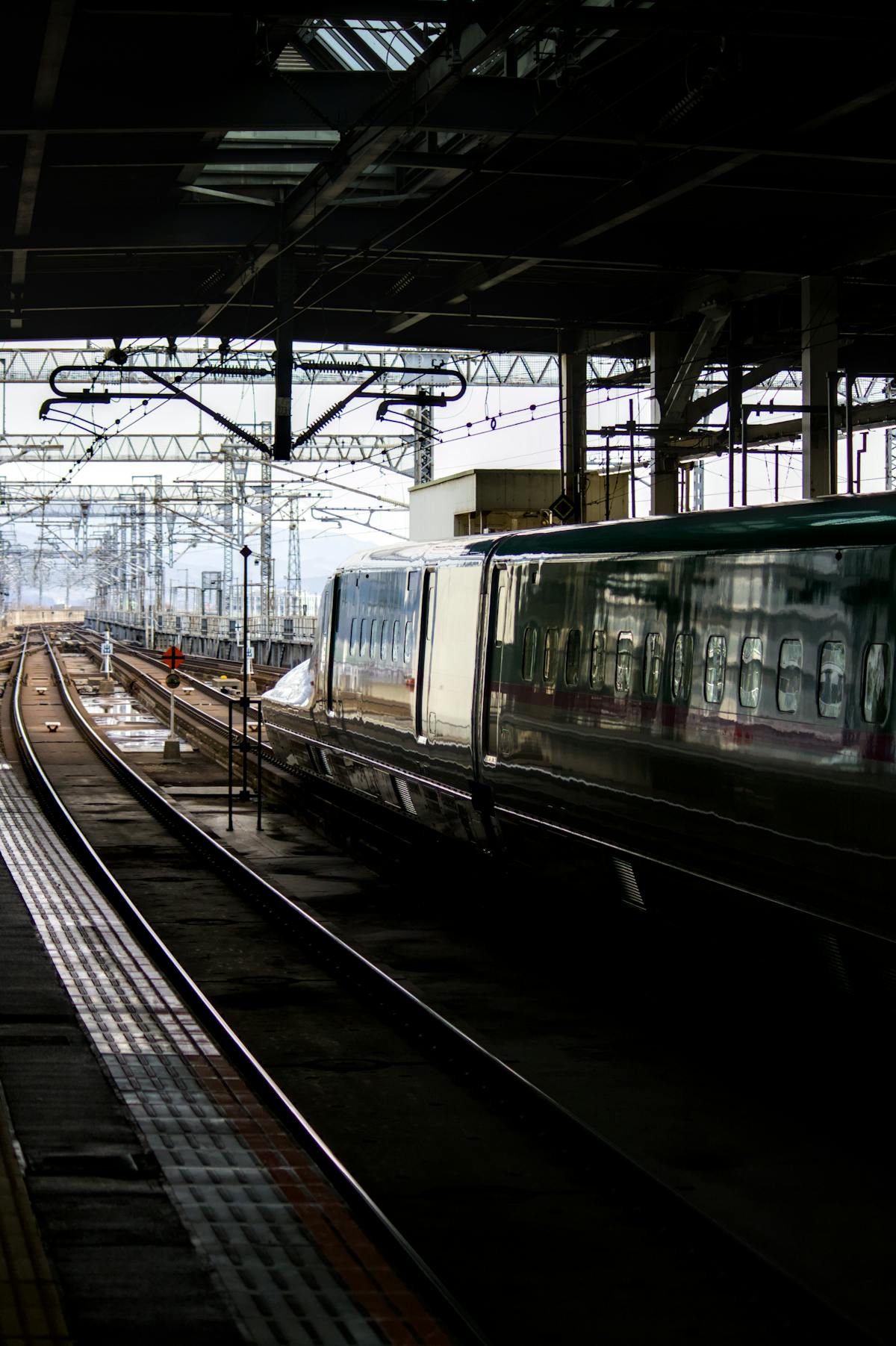 Shinkansen bullet train departing from a station in Japan
