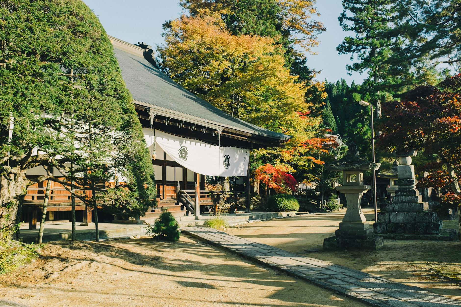Buddhist temple set against vibrant fall colors in Takayama Japan