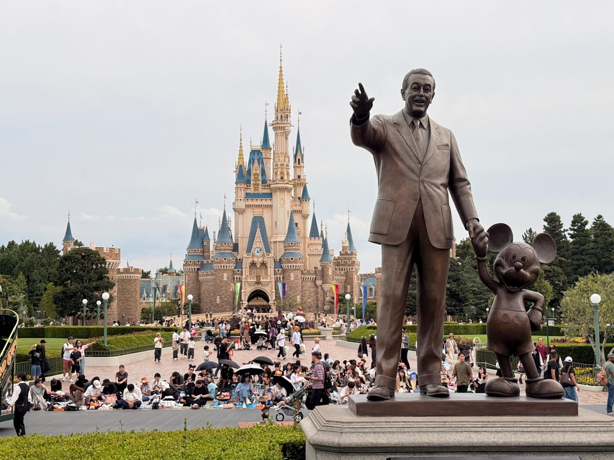 Walt Disney and Mickey Mouse statue in front of Cinderella Castle at Tokyo Disneyland