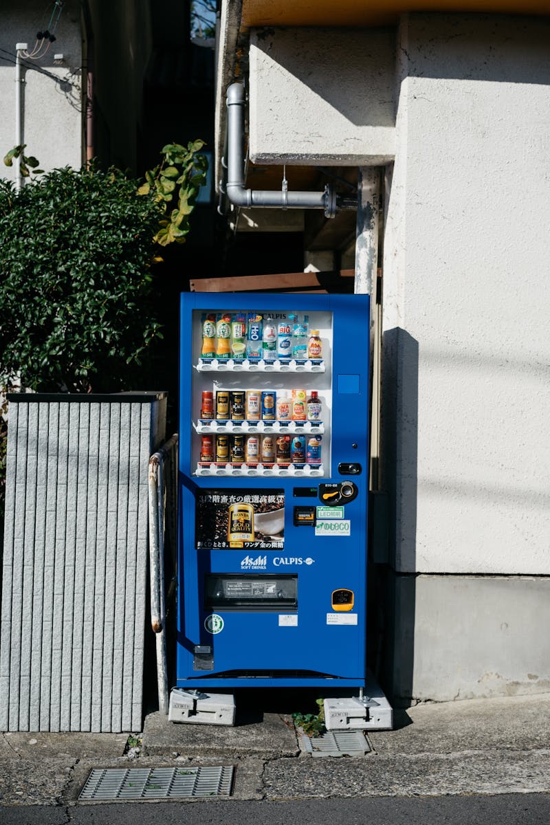 Blue beverage vending machine on a street in Japan