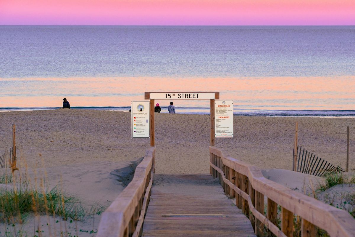 Virginia Beach shoreline at sunset with soft pastel colors reflecting on the water