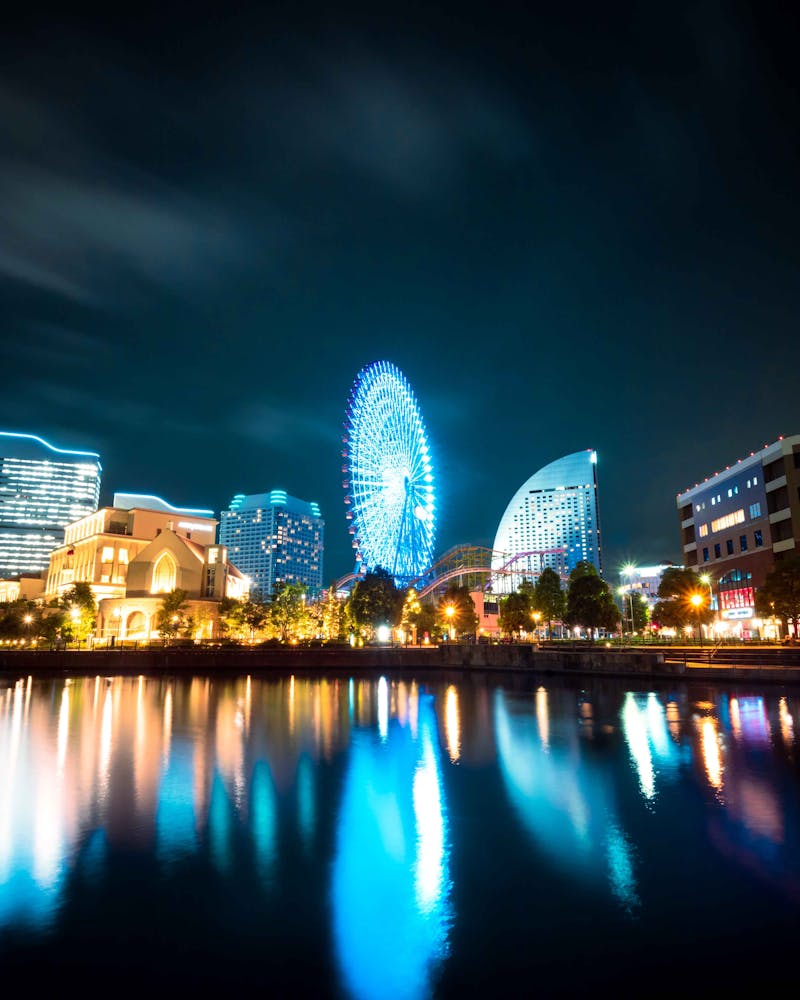 Yokohama skyline with Ferris wheel reflections on water at night