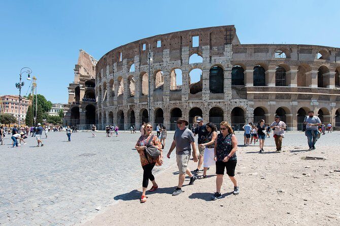Combo: Colosseum, Vatican Museums and Sistine Chapel Guided Tour - Entering the Colosseum: levels 1 and 2, with the guide doing the heavy lifting