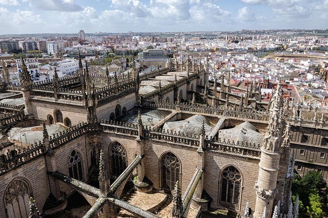 Seville Guided Tour into Alcazar and Cathedral Skip the Line - Giralda Tower: a minaret past, Christian bells above, and views that finish the story