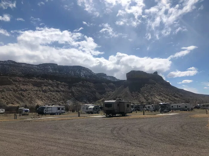 mountain view in the Palisade RV basecamp with more than 10 white RV parked at camp